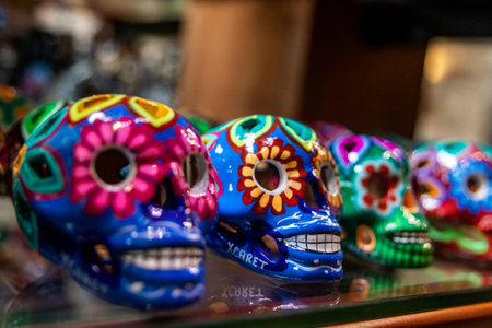 Xcaret - Mexico November 22, 2022: Colorfully painted clay skulls on a shelf with the typical of Mexico. A clay skull is a figure of a skeleton commonly used for decoration during the Day of the Dead.のeditorial素材