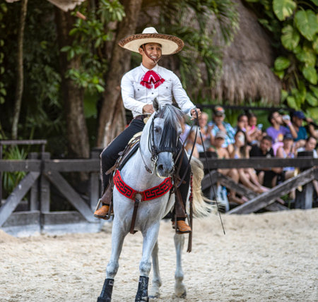 Xcaret, Mexico - December 19, 2022 - Horseman also known as Mexican charro in a magnificent exhibition of movements with the sliding lasso on a spectacular Aztec horse of great lineage.のeditorial素材
