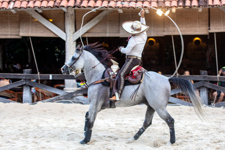Mexican equestrians with a magnificent exhibition of running lasso movements on Aztec horses of great lineage, this is a unique show at Xcaret Park in Mexico.の写真素材