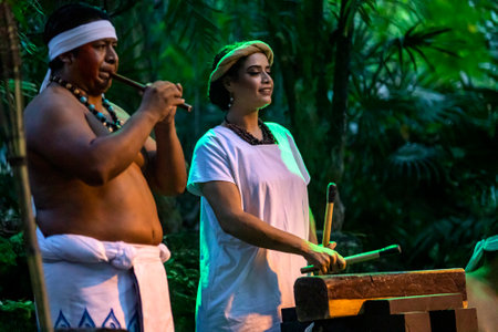Xcaret, Mexico, December 21, 2022 - Mayan musician couple preparing the dance and combat of the Mayans in the park of Xcaret in Mexico, it is a pre-Hispanic civilization with an old and unique cultureのeditorial素材