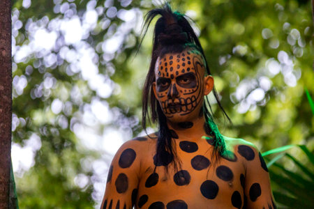 Xcaret, Mexico, December 24, 2022 - Great Mayan warrior preparing for dance and battle in the Mayan Riviera of Mexico, in the Xcaret park which is a very busy place for travelers and tourists.のeditorial素材