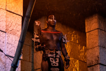 Xcaret, Mexico, December 25, 2022 - Muscular Mayan jaguar warrior in the rainforest protecting the ancient Mayan civilization with its ruins and cities as Xcaret Park in the Mexican Mayan Riviera.のeditorial素材
