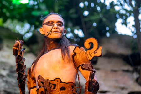 Xcaret, Mexico, January 24, 2023 - Warrior in Xcaret in the ancient Mayan civilization prepared for the owl dance and fight in the tropical jungle of the Riviera Maya in Mexico.のeditorial素材