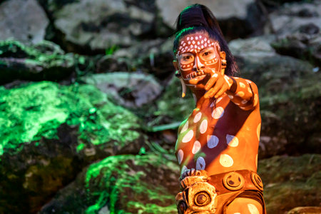 Xcaret, Mexico, January 24, 2023 - Jaguar warrior of the ancient Mayan civilization at Xcaret prepared for the owl dance and fight in the tropical jungle of the Riviera Maya in Mexico.のeditorial素材