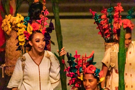 Xcaret, Mexico - January 26, 2023: Mexican women performing in a multicultural show at Xcaret Park in the middle of the tropical jungle of the Mayan Riviera in Mexico.のeditorial素材