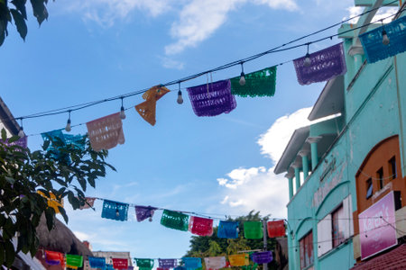 Playa del Carmen, Mexico, April 2, 2023: Flags on the fifth avenue of the Mexican city of Playa del Carmen, the most commercial street of this Mexican town which is full of tourists and foreigners.のeditorial素材