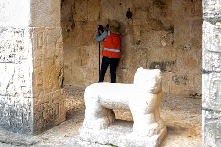 Archaeologist working in one of the ancient Mayan ruins of Chichen Itza in the Yucatan Peninsula, the ancient Mayan ruins of the Mayan civilization.の写真素材