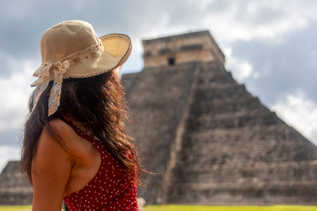 Sexy tourist woman enjoying and visiting the pyramid of Chichen Itza in the Yucatan peninsula, this...
