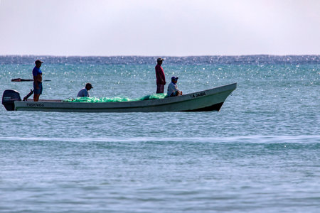 Playa del Carmen, Mexico; May 9, 2023: fisherman on his boat fishing in the Caribbean Sea, specifically on the coast of the famous and beautiful Mexican Mayan Riviera.のeditorial素材