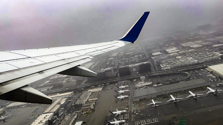 Aircraft after departing from a runway of Los Angeles International Airport and flying over it, in...