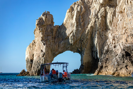 Cabo San Lucas, Mexico, September 6, 2023: Tourist boat visiting Cabo San Lucas's famous arch, which separates the Pacific Ocean from the Sea of Cortez.のeditorial素材