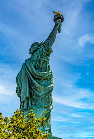 Photograph of the incredible and democratic Statue of Liberty in New York (USA), on a hot and bluish Big Apple day, typical of Manhattan.の写真素材