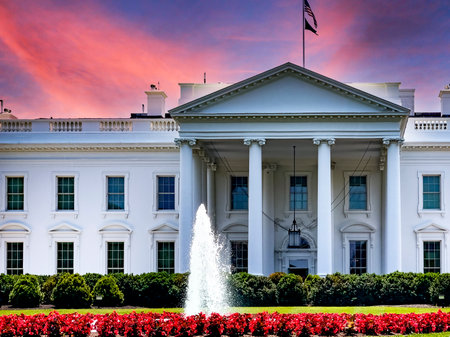 The white house located in the American capital of Washington DC, under a reddish-orange sky at sunrise or sunset, in the United States of America.の写真素材