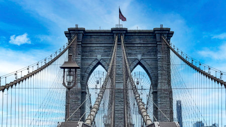 The famous and wonderful Brooklyn Bridge linking the boroughs of Manhattan and Brooklyn in New York City (USA), a day with blue sky and lots of clouds.の写真素材