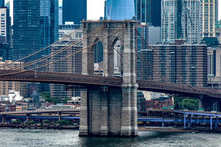 The famous Brooklyn Bridge linking the boroughs of Manhattan and Brooklyn in New York City (USA), this bridge is one of the most famous and well known in the Big Apple.の写真素材