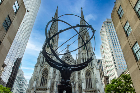 Bronze statue of the giant Atlas, facing and looking at St. Patrick's Cathedral on Fifth Avenue, in the heart of Manhattan, New York City (USA).の写真素材
