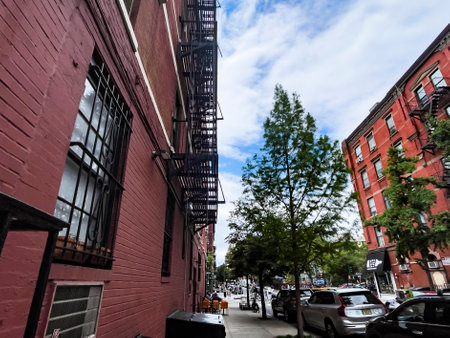 Walking and enjoying the typical neighborhoods like the Bronx of New York City, with its brick buildings and exterior fire escapes and emergencies.の写真素材