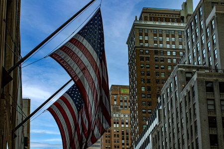 American flags flying on the skyscrapers in the middle of Manhattan, in the streets of the Big Apple...