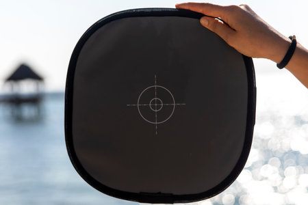 A gray card measuring the light of a Caribbean beach, to get a correctly exposed photograph by...