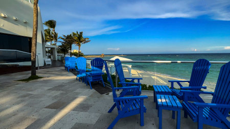 Perfect blue seats to relax on a white sandy Caribbean beach, while enjoying the Mexican Caribbean and crystal clear turquoise waters, ideal for summer vacations.の写真素材