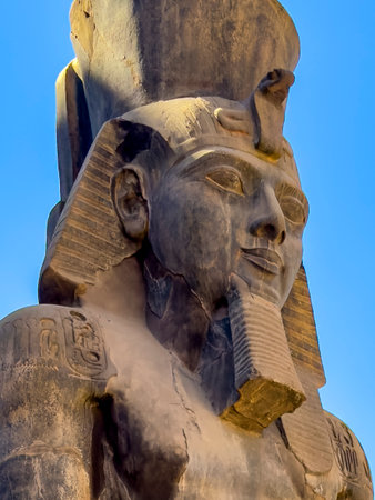 Gaze upon the colossal statue of Ramses II, Egypt's timeless guardian, at the Luxor Temple. This...