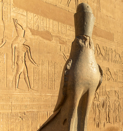 Discovering the enigmatic statue of Horus, represented in this falcon statue this powerful god, so important for the ancient Egyptian mythology, guarding the temple of Edfu in Egypt.の写真素材
