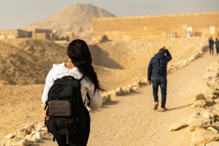 Follow an adventurous tourist as she backpacks through Egypt's ruins, exploring mysterious tombs and pyramids. Discover the ancient wonders of this historic land.の写真素材