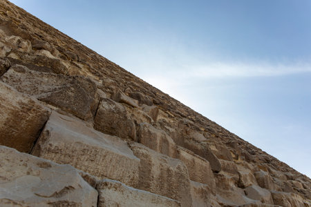 At the ancient stones, a modern wonder, of Khufu's Pyramid in Giza, Egypt's landmark. Experience the grandeur and historical significance of this site.の写真素材