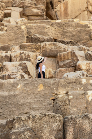 Experience a Cheops Pyramid adventure with a tourist at Giza's modern wonder, Egypt. Discover the history and grandeur of this iconic world landmark.の写真素材