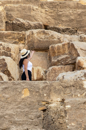 Join an adventurous tourist at the Great Pyramid of Giza, Egypt, one of the modern world's wonders. Explore the ancient marvels and breathtaking views.の写真素材