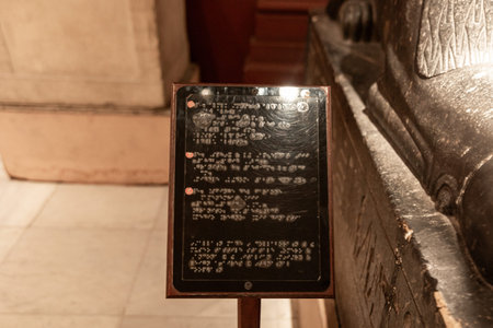 Museum information panel displayed next to an ancient Egyptian coffin inside a museum in Cairo,...