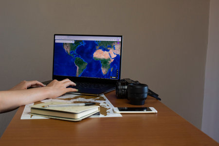 Woman looking for her next destination around the world on the computer