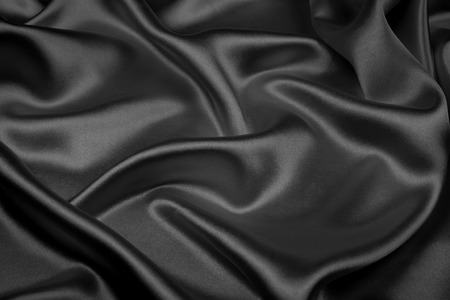 Black silk texture luxurious satin for abstract background. Dark tone of fabricの写真素材