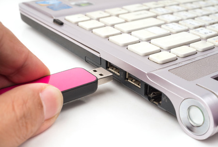 USB Pink flash drive stick being connected to computer, selective focusの写真素材