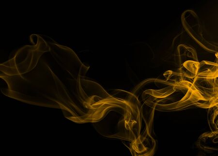 Yellow smoke abstract on black background, fire designの写真素材