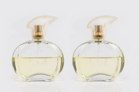 Glass bottle filled with perfume on white backgroundの写真素材