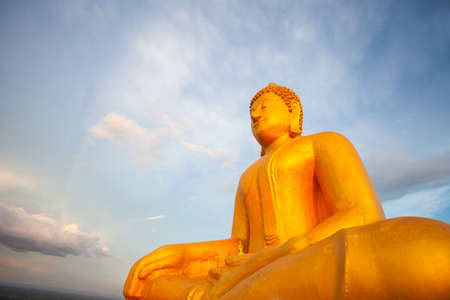 Golden buddha on blue sky with cloud nature background, selective focusの写真素材
