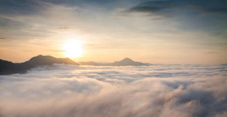 Mountain with white mist in morning sunrise, nature landscapeの写真素材