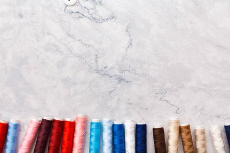 colorful sewing and tailoring tools and items on light background