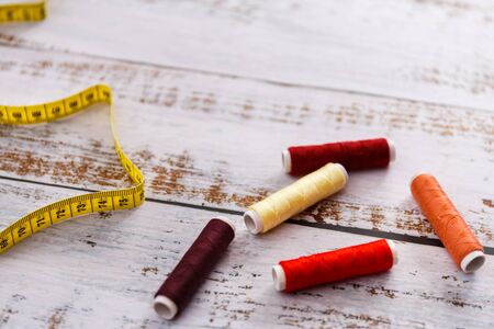 colorful sewing and tailoring tools and items on light background
