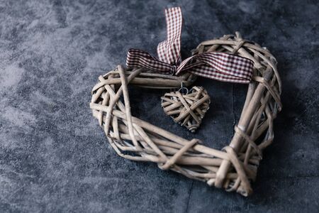 wooden heart on dark background with copy space for valentines dayの写真素材