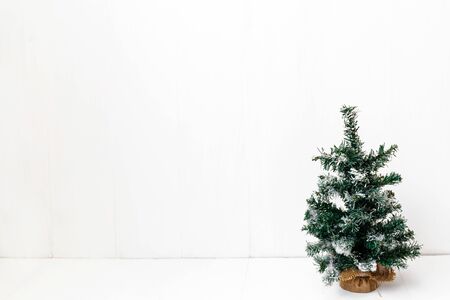 Decorative artificial small Christmas tree on a white background isolatedの写真素材