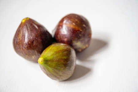 Fresh italian figs on white wooden background. Sweet summer dessert.