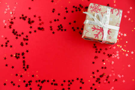 Red background with christmas items and glitter stars