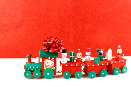 Little toy train with christmas figures. Holiday greeting card.