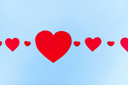 Valentine's Day background. Hearts on pastel blue background. Valentines day concept. Flat lay, top view, copy spaceの写真素材