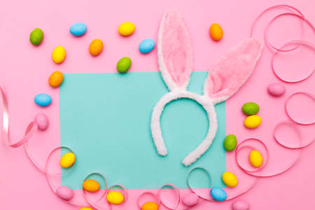 Easter bunny. Happy Easter holiday background concept.Flat lay colorful bunny egg with accessory to...