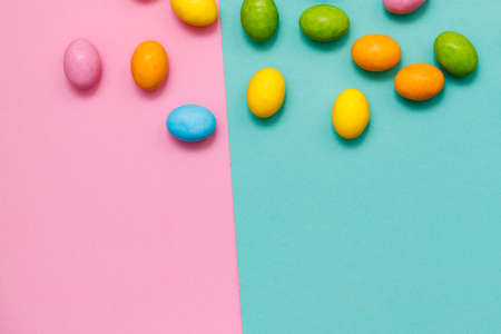 Easter bunny. Happy Easter holiday background concept.Flat lay colorful bunny egg with accessory to celebration on modern rustic pink pastel paper at home office desk.の写真素材