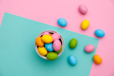 Easter bunny. Happy Easter holiday background concept.Flat lay colorful bunny egg with accessory to celebration on modern rustic pink pastel paper at home office desk.の写真素材