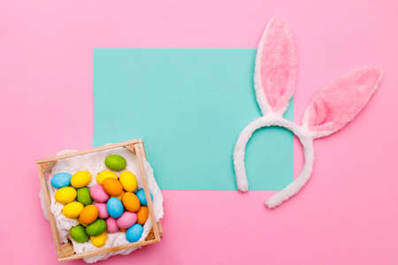Easter bunny. Happy Easter holiday background concept.Flat lay colorful bunny egg with accessory to...